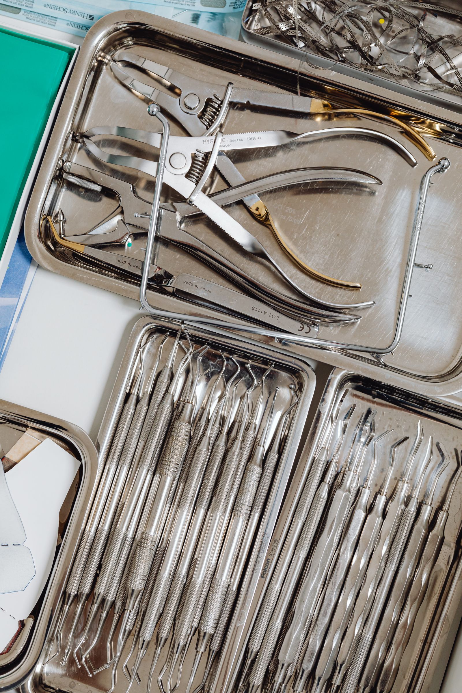Dental hand instruments arranged in stainless steel trays.
